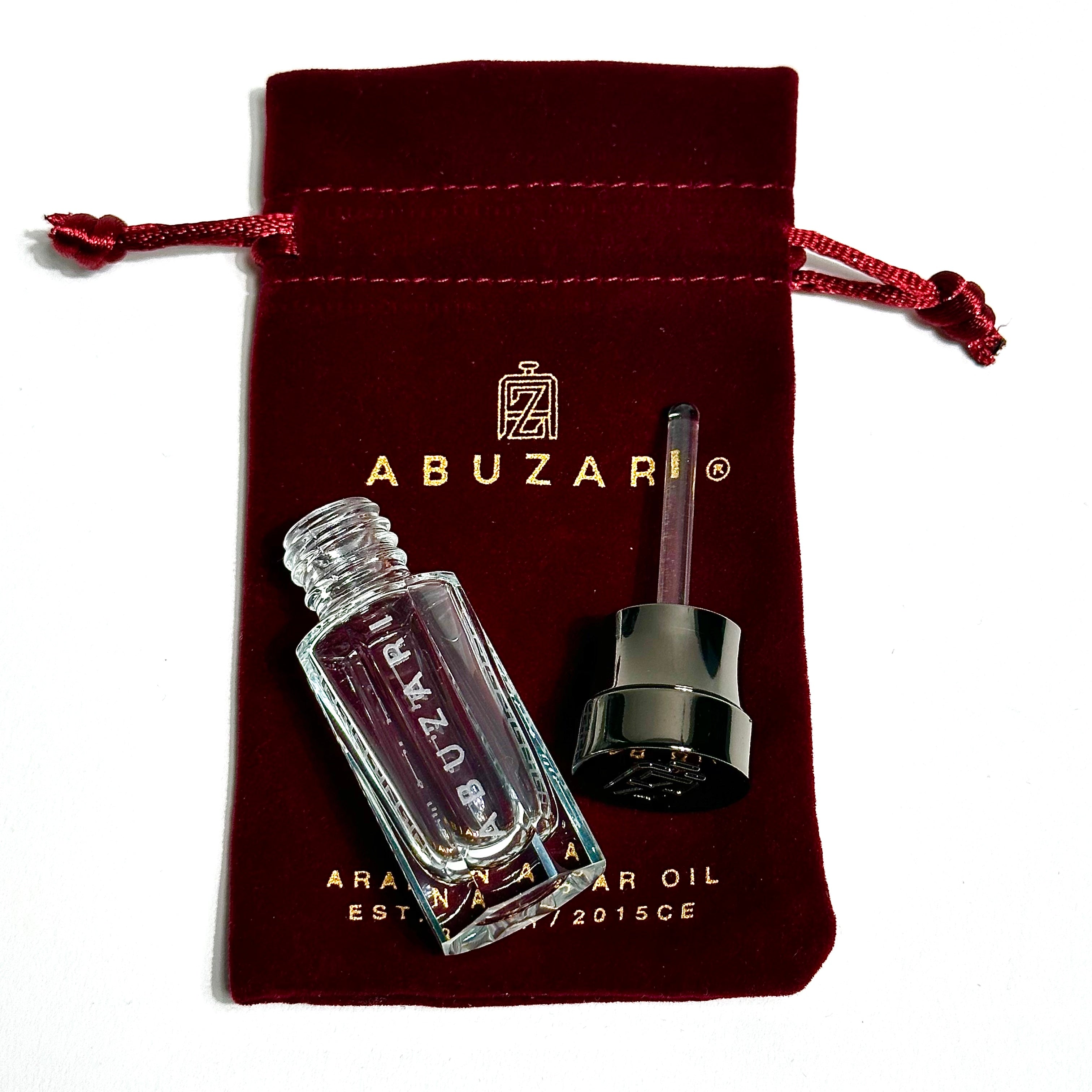 Abu Zari velvet pouch with empty Abu Zari perfume bottle and detached glass stick applicator and cap.