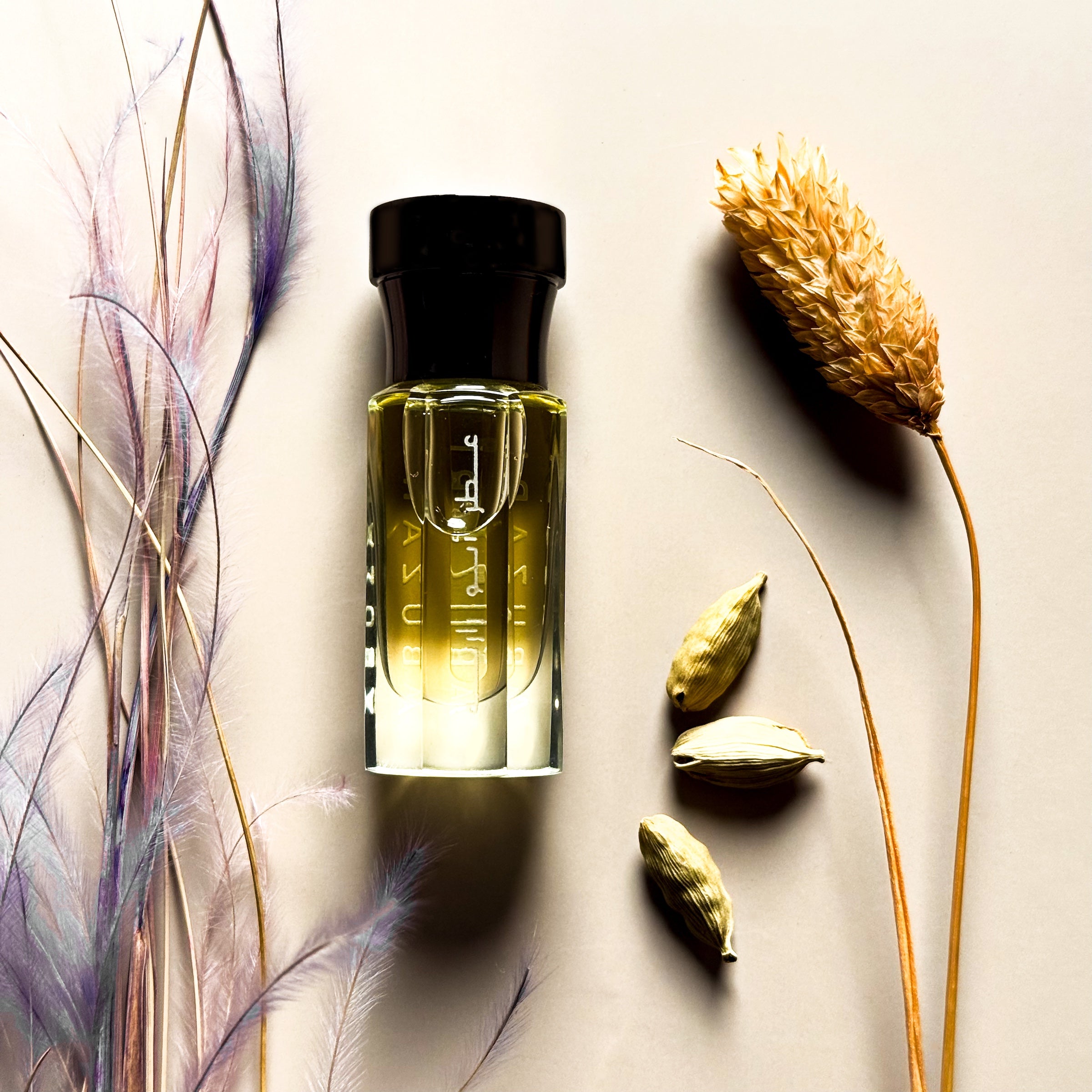 Perfume bottle with dried flowers and seeds on a neutral background