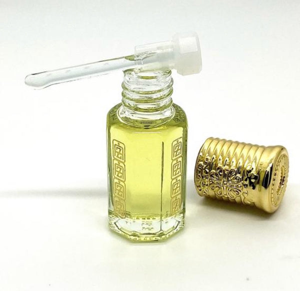 White Oud Arabian Perfume oil inside of Abu Zari USA brand attar bottle with Abu Zari USA logo, glass stick applicator and gold royal crown cap detached.