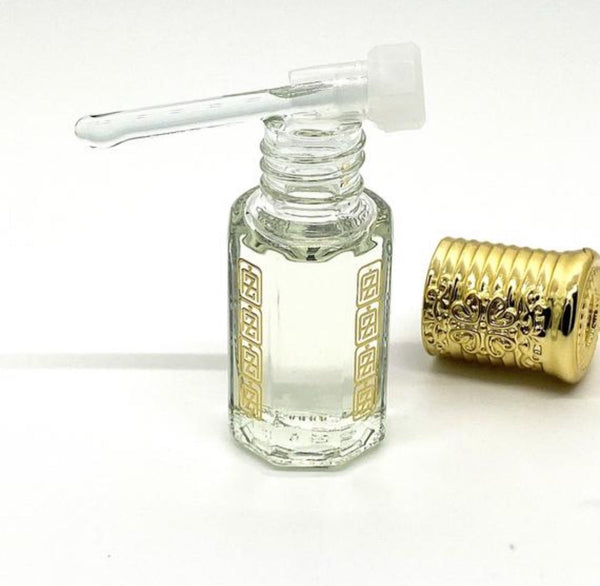 saudi white arabian perfume oil inside abu zari brand attar bottle, gold crown cap and glass stick applicator